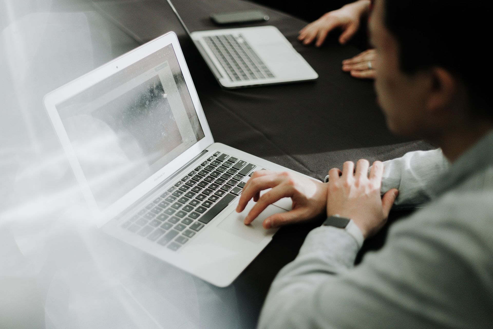 People using laptops sitting at a table